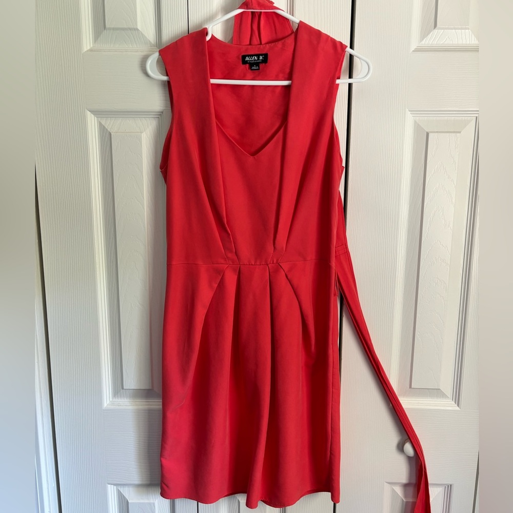 Coral dress with flattering cut and warp around sash.
